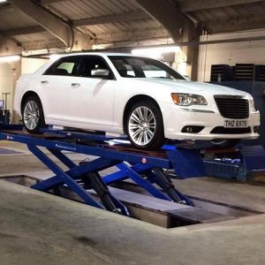 White car on scissor lift